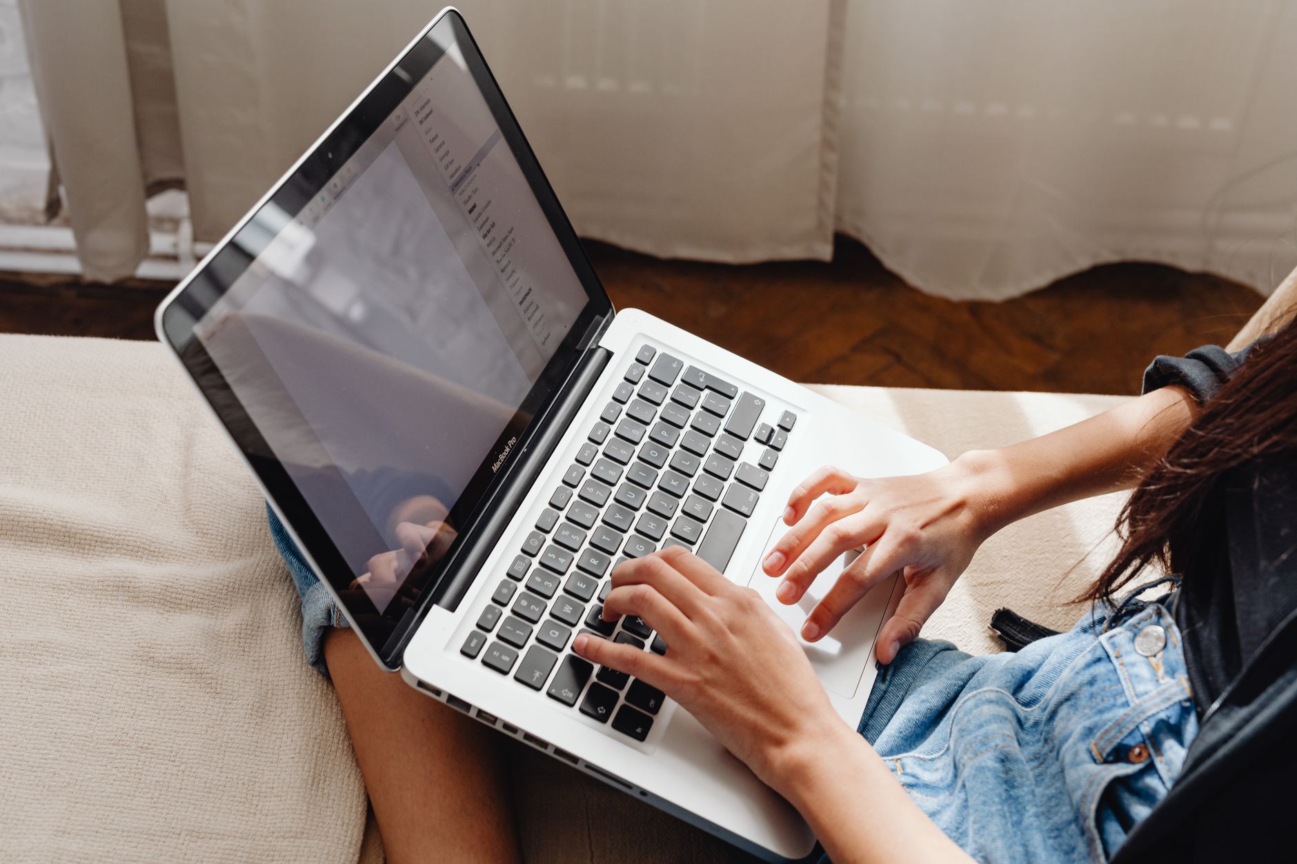 Person clicking delete account button on a laptop in a calm home office setting.