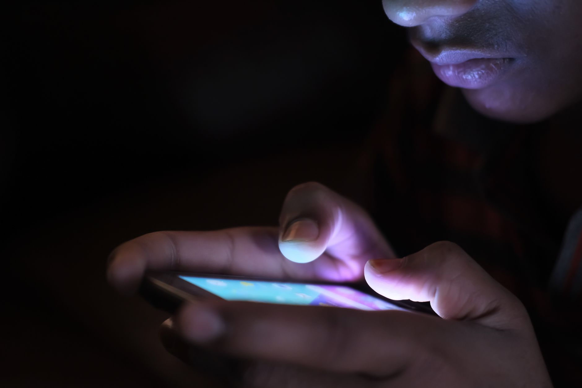 Person holding a smartphone and completing a personal information removal request form on a website.