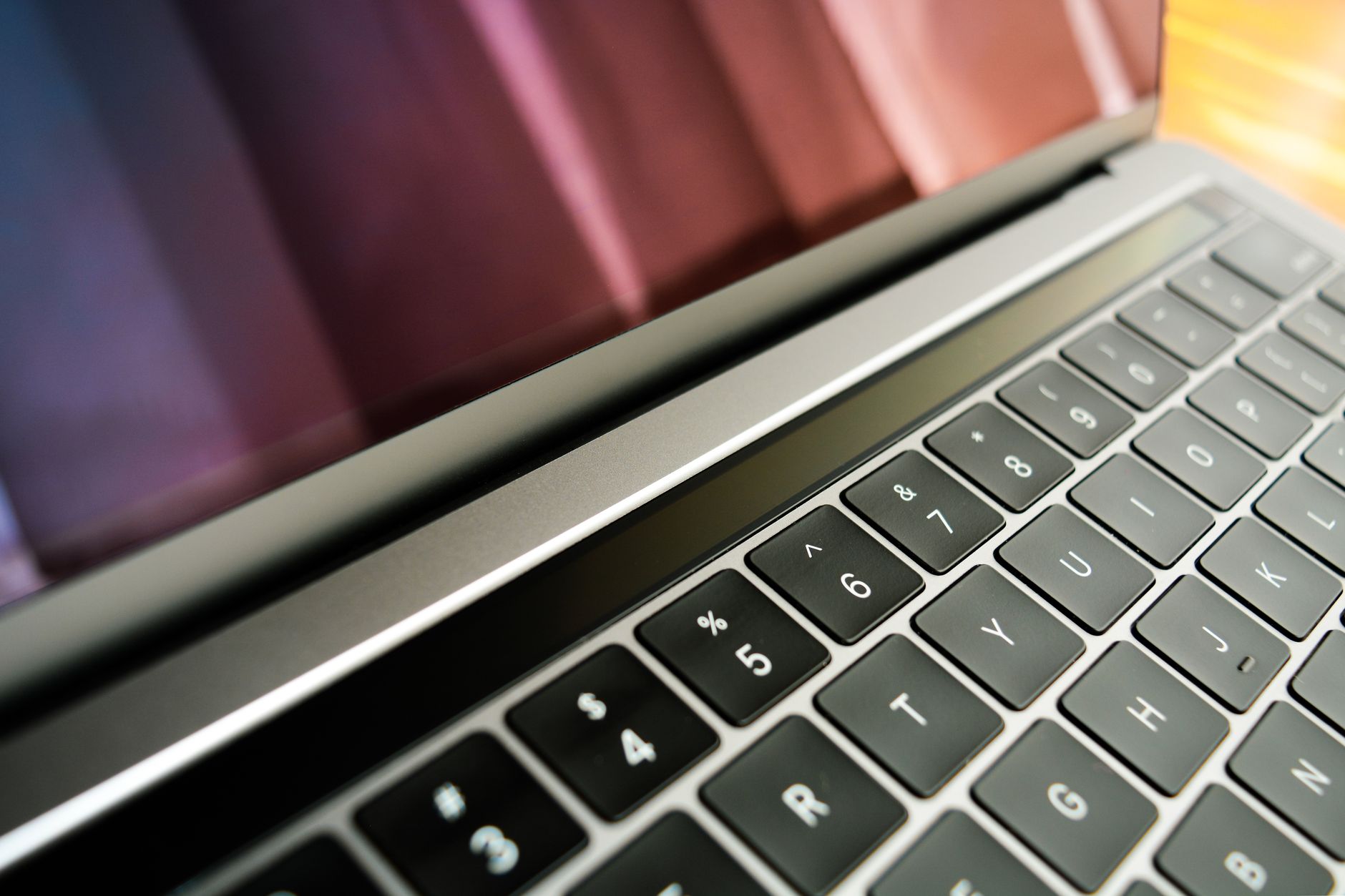 A close view of a laptop screen with a privacy filter attached, showing a darkened side angle.