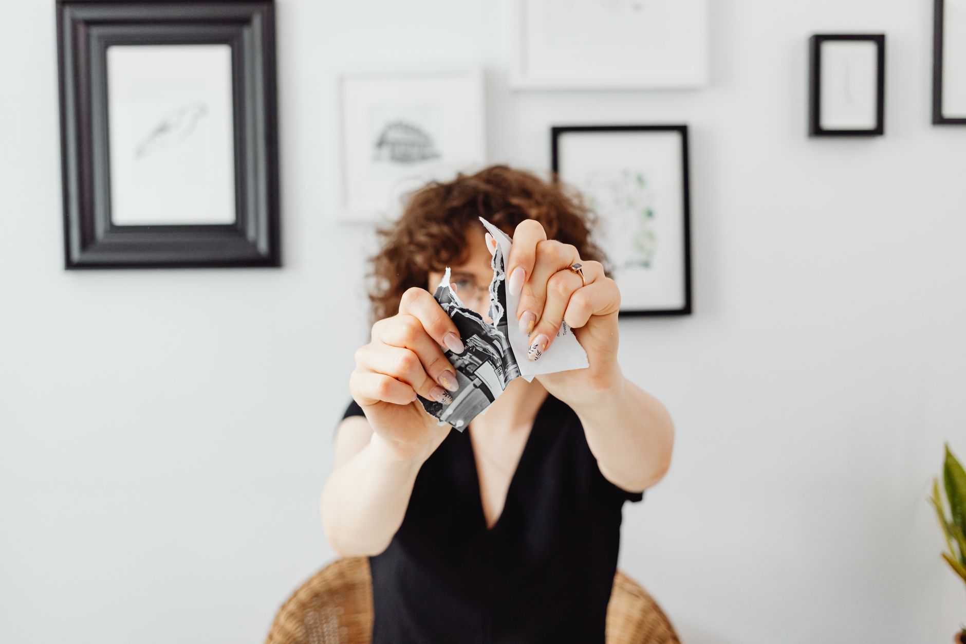 Hands feeding paper into a shredder, representing protecting personal information from identity theft